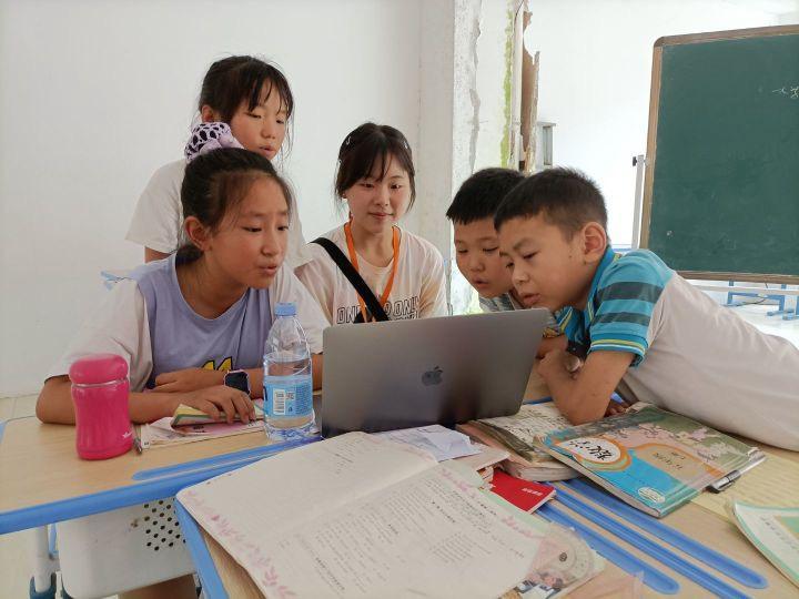 图为学生和志愿者一起挑选合唱曲目。作者 余凯