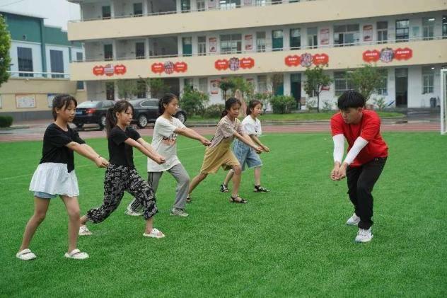 ﻿图为南阳师范学院体育学院实践队员为红军小学学生进行排球专项教学