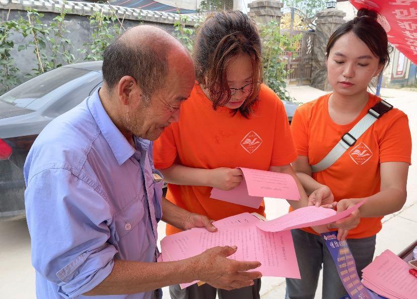 图为河南科技学院外国语学院学子向当地村民宣传新理论新思想，助力乡亲们了解新局势新情况 中国青年网 通讯员 汪洋 供图