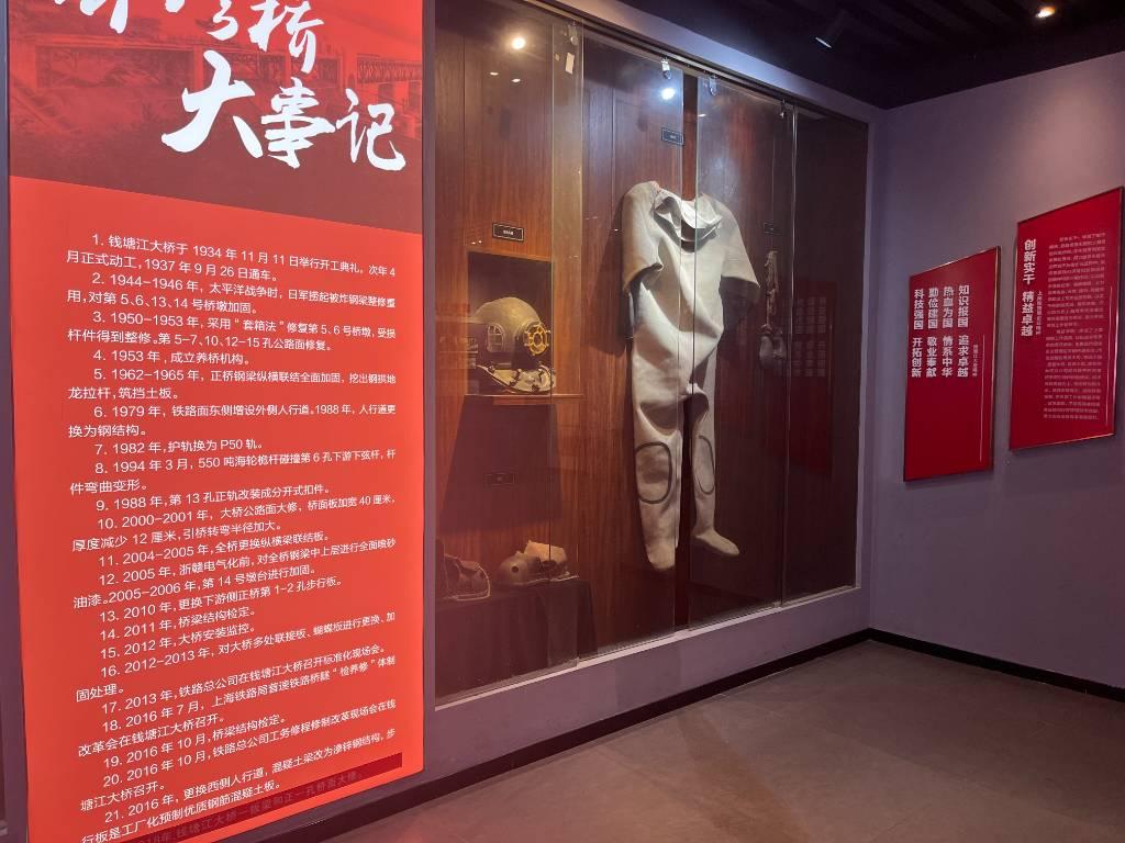 图为钱塘江大桥陈列馆内关于钱塘江大桥大事记的展板内容及展示物