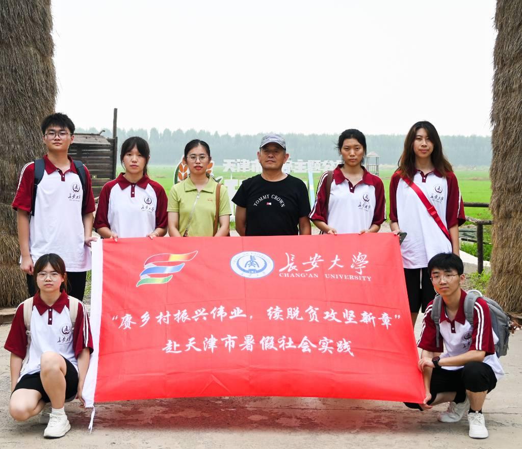 图为实践队成员与驻村第一书记朱桂水在稻香花海园大门前合影， 图为实践队成员与驻村第一书记朱桂水在稻香花海园大门前合影