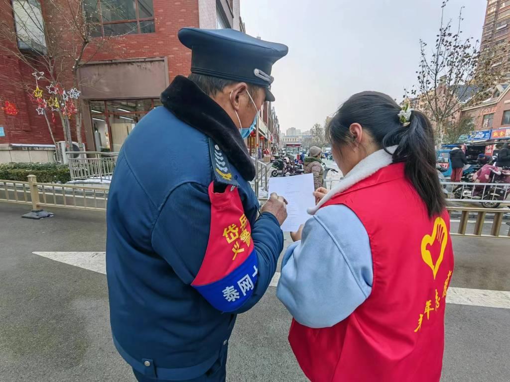 图为团队成员向社区门卫进行线下问卷调查。中国青年网通讯员 周梦宇 供图